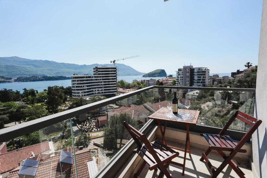 Balcony table with sea and mountain view over Budva